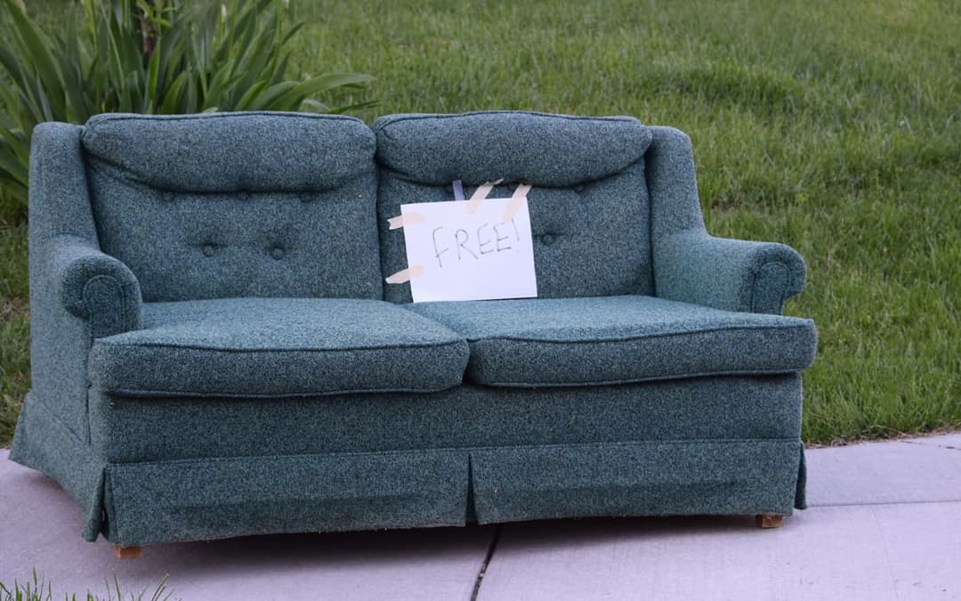 preloved sofa with 'free' sticker on it 
