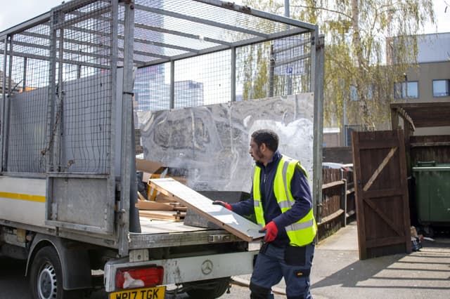 bulky waste collection Reading workers loading household waste into truck