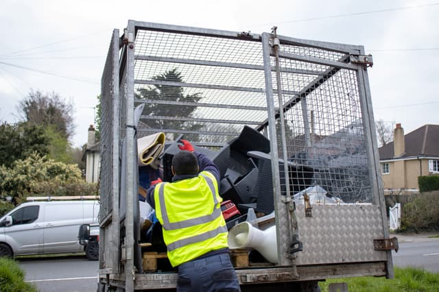 bulky waste collection Guildford workers loading household waste into truck