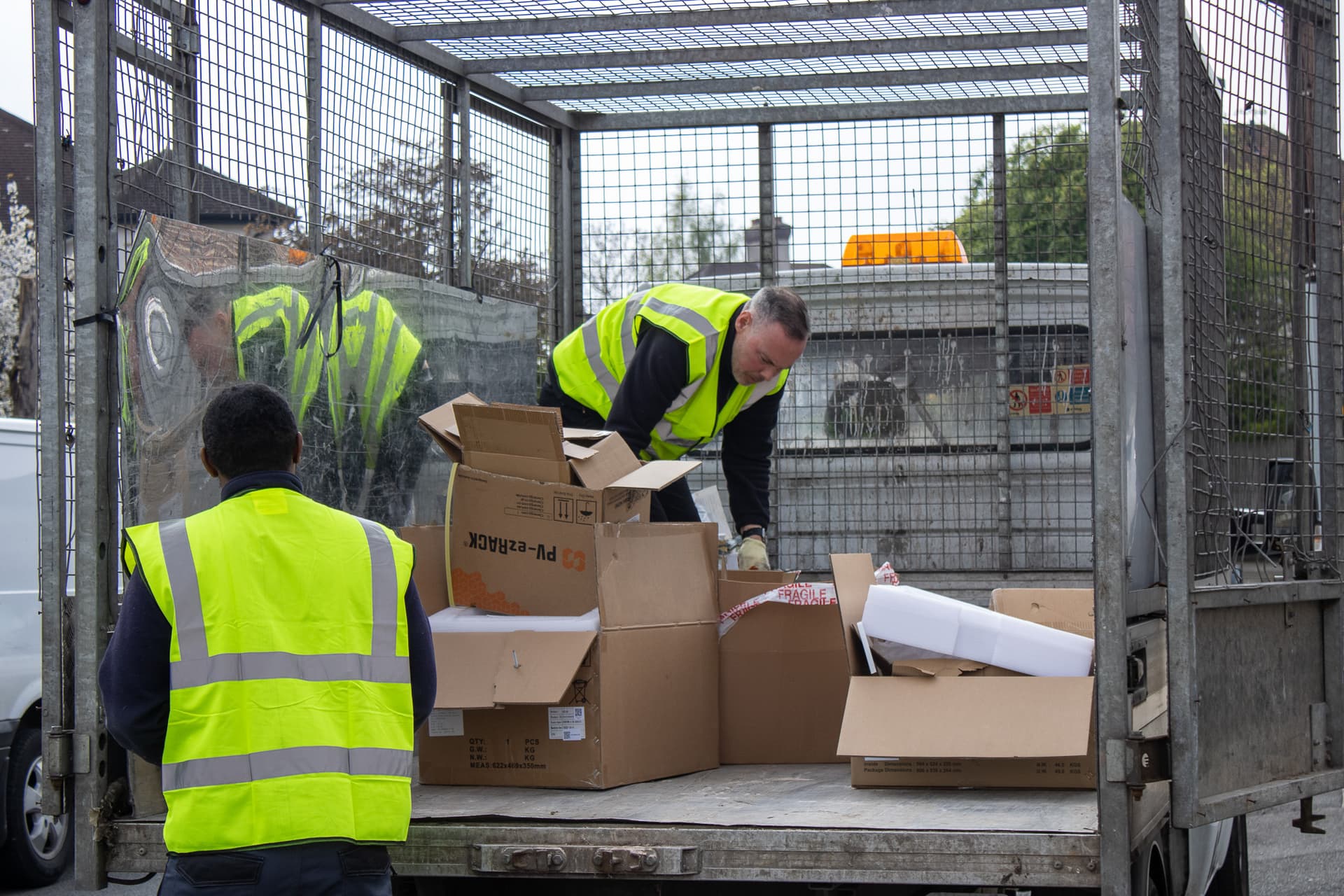 bulky waste collection Birmingham workers loading cardboard and household waste into truck