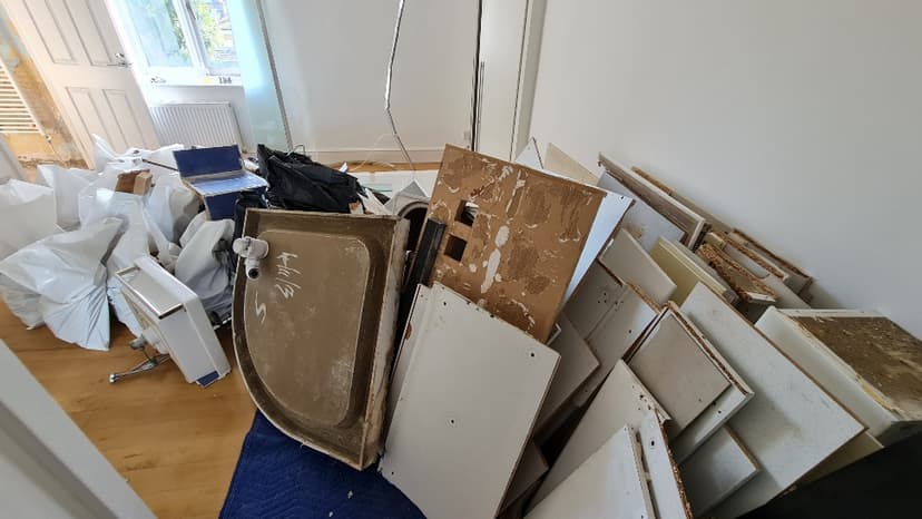 pile of household rubbish and bulky waste outside property in Hackney