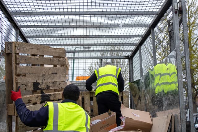 bulky waste collection Norwich workers loading household waste into truck