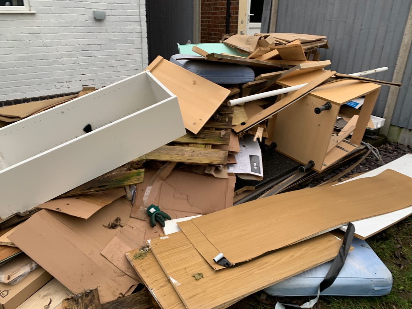 pile of household rubbish and bulky waste outside property in Surrey