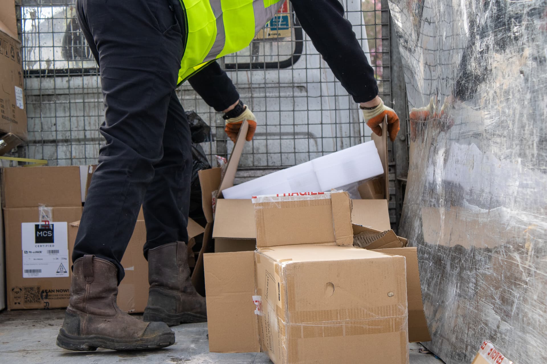 bulky waste collection Milton Keynes workers loading cardboard and household waste into truck