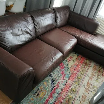 Brown leather sofa collected for free by a junk reuser