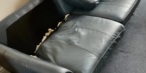 second hand sofa with visible wear and tear
