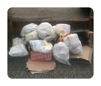 pile of rubbish bags and cardboard waste